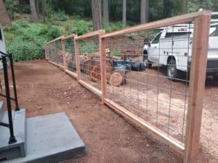 Newly constructed tiered wire panel with wood frame | Wire mesh fence